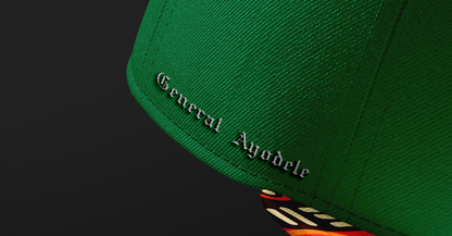 Side view of the General Ayodele Snapback highlighting the embroidered name detail and the vibrant geometric pattern on the brim.